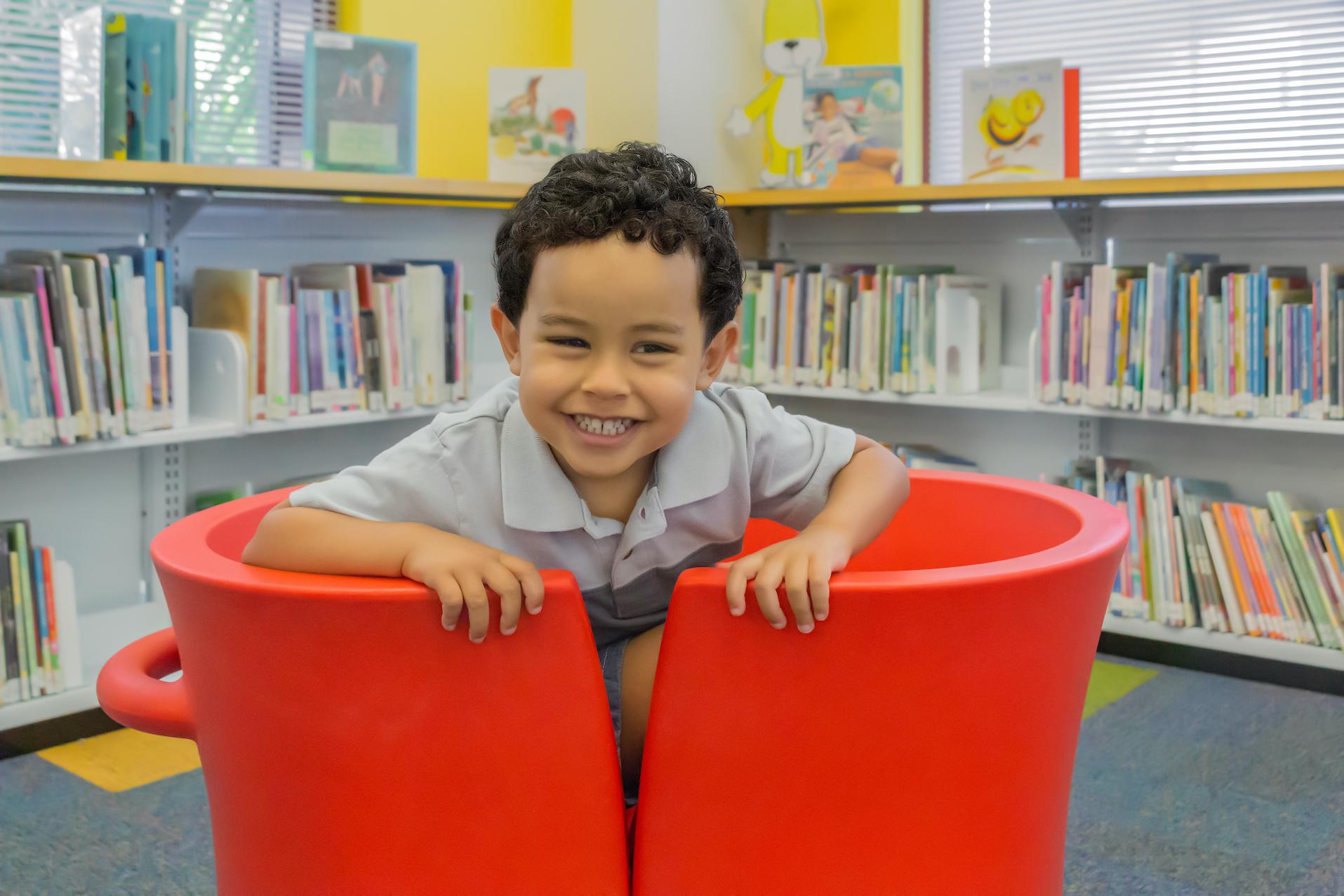 A smiling child at the library